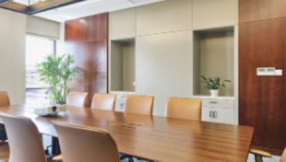 A conference room with a long table and chairs